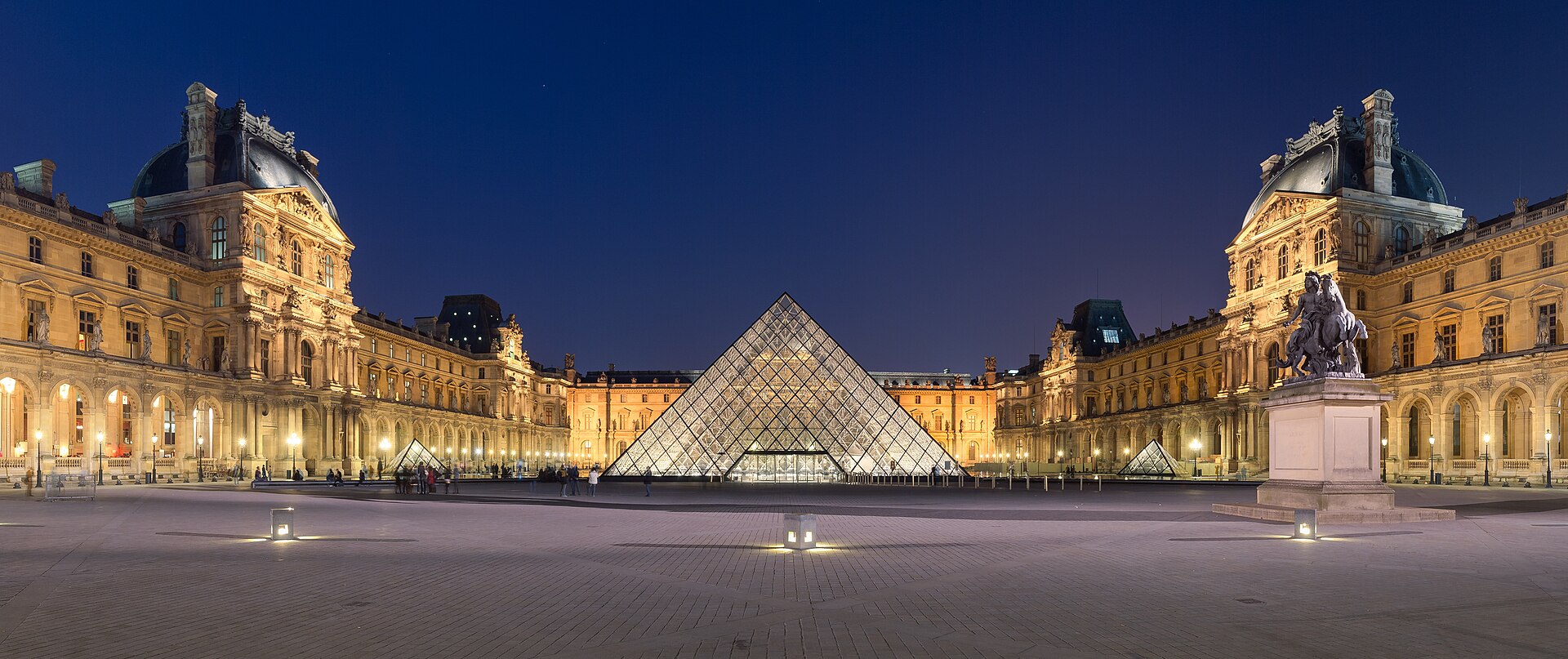 The illuminated Louvre pyramid in the Cour Napoléon at night